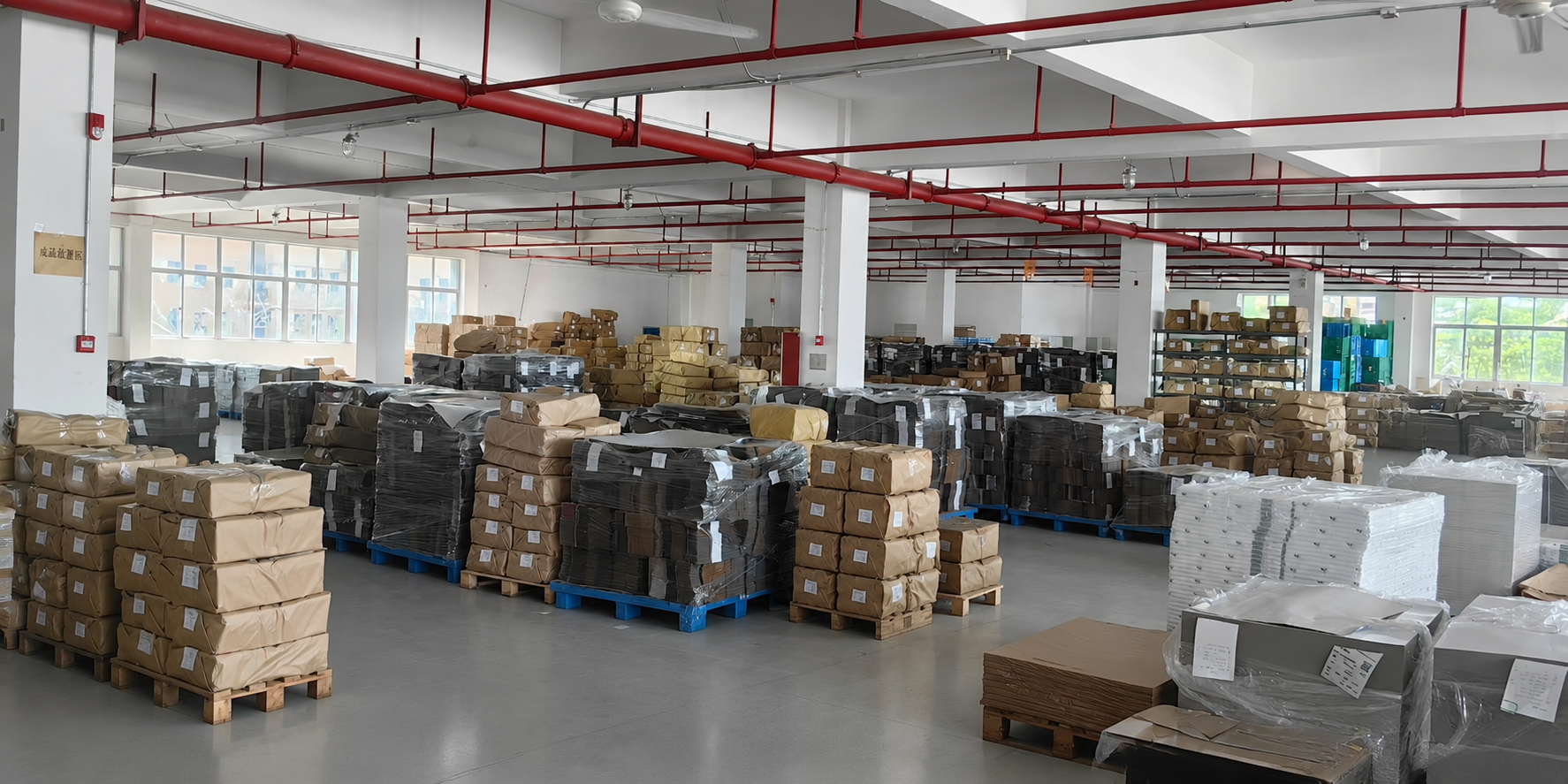 Packed production batches staged on pallets inside the XJY factory
