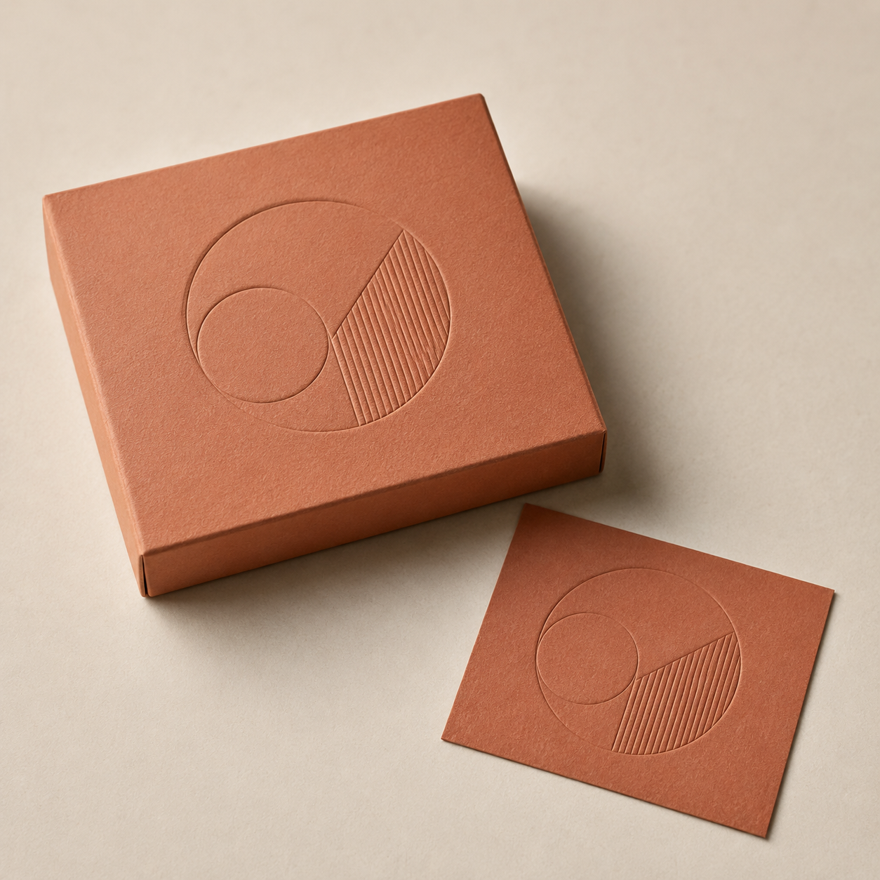Representative terracotta paper box with a recessed blind debossed motif