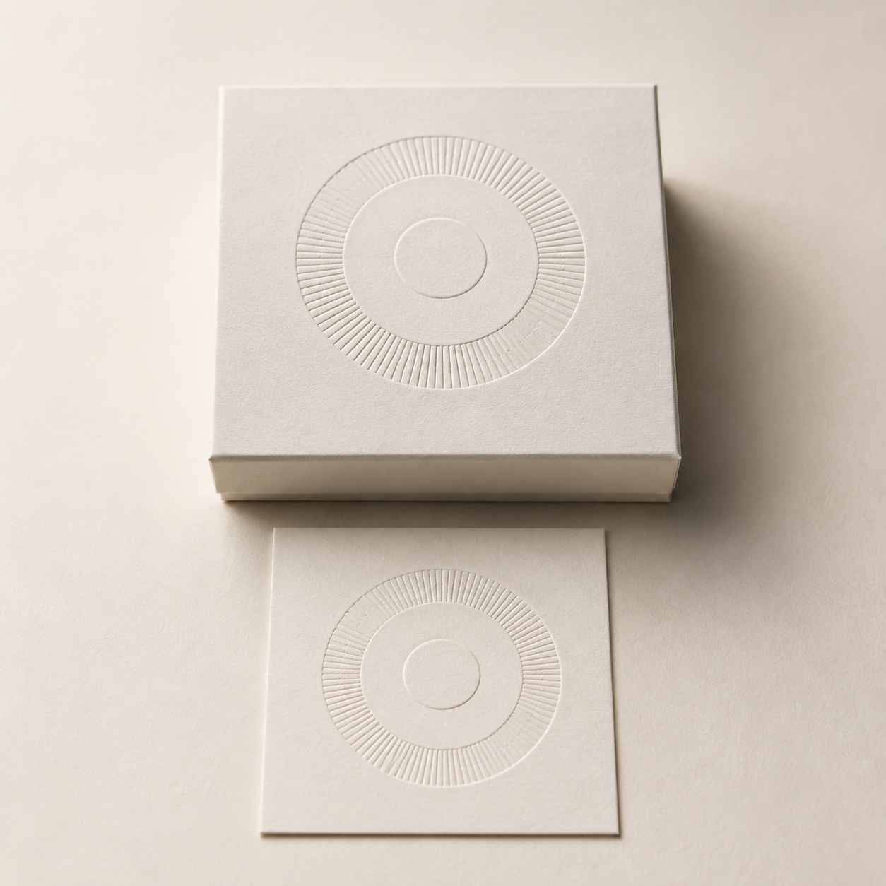 Representative white paper box with a raised blind embossed motif